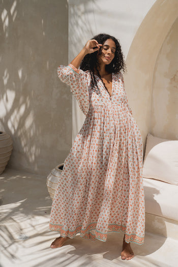 Daughters of India Kyra Maxi Dress in Coral — full length in sunlit courtyard with palm shadows, hand block print cotton