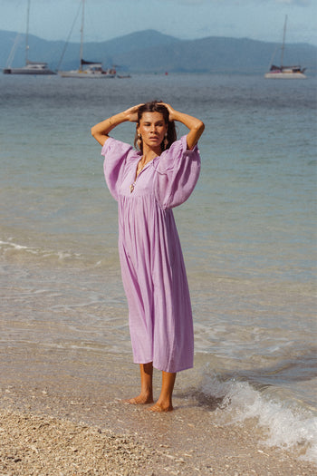 Daughters of India Kyra Midi Dress in Lilac Gauze — full length on beach with sailboats, billowed sleeves, cotton gauze