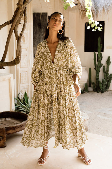 Daughters of India Kyra Midi Dress in Olive — full length in Bali villa courtyard with cactus, V-neckline, flowing skirt