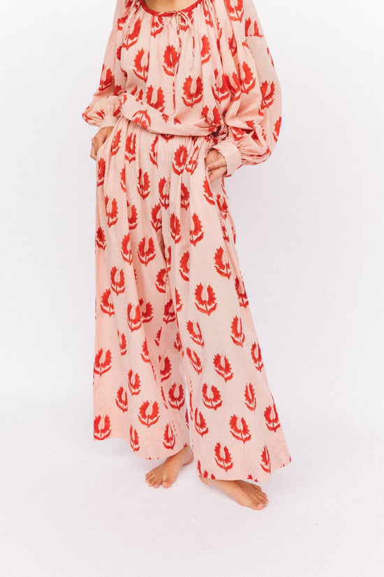 Ria Pants Cherry Blossom — studio waist and hip detail, cherry blossom hand block print cotton wide-leg pants with elastic drawstring waist, pink floral motif on cream, artisan Jaipur India | Daughters of India