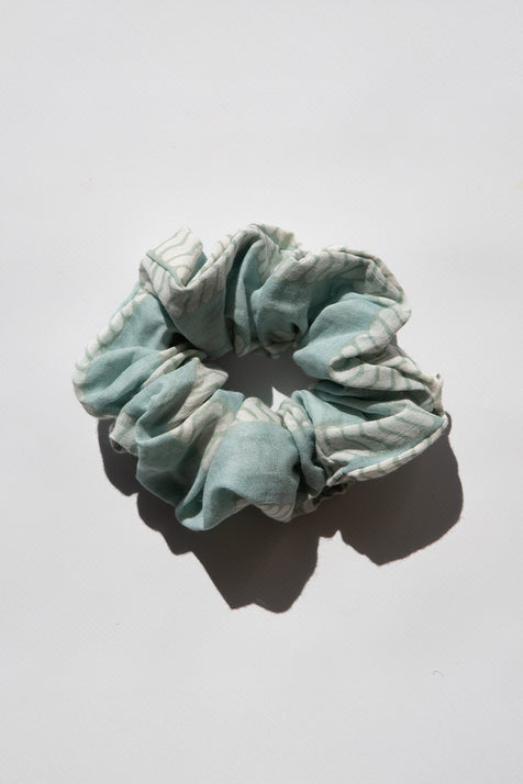 Daughters of India Upcycled Scrunchie in Sea Mist, a light teal striped hair scrunchie made from upcycled cotton fabric, flat lay view